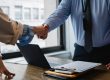 Two people shaking hands during a professional business meeting