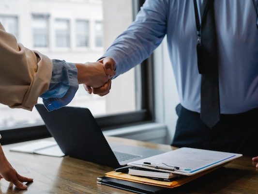 Two people shaking hands during a professional business meeting