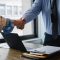 Two people shaking hands during a professional business meeting