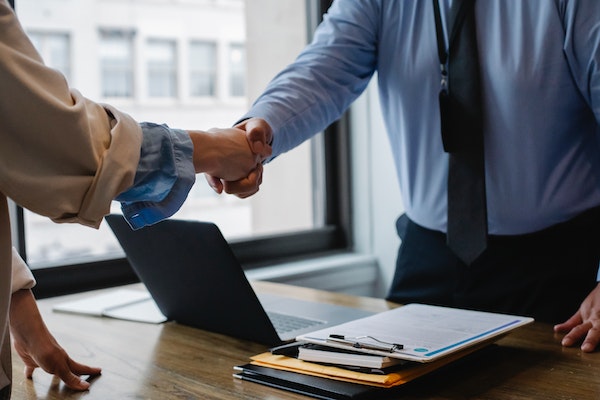 Two people shaking hands during a professional business meeting